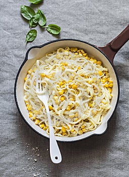 Creamy corn pasta in a cast iron skillet on a light background