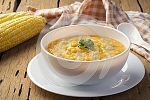 Creamy corn Pottage soup on white bowl