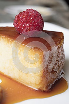 Creamy Flan dessert served with raspberries and dulce de leche