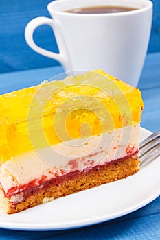 Creamy fruit cake with jelly and cup of coffee for different occasions. Festive dessert