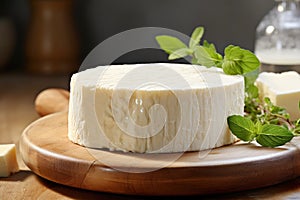 Creamy goat cheese on a rustic wooden board with fresh herbs - a gourmet still life