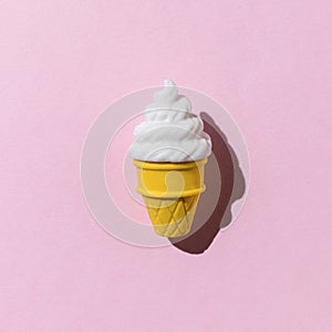 Creamy ice cream in a waffle cup on a pink background