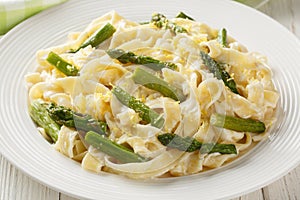 Creamy Lemony Asparagus Pasta fettuccine closeup on the plate. Horizontal