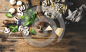 Creamy mushroom pasta spaghetti in cast iron pan with basil