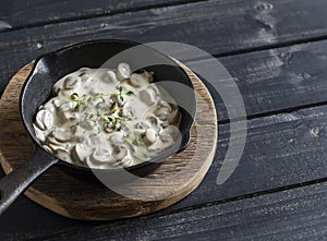 Creamy mushroom sauce in a pan on a wooden rustic board