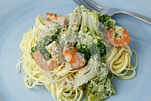 Creamy pasta with broccoli and shrimp and a glass of red wine