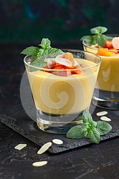Creamy peach dessert with peach pieces and mint