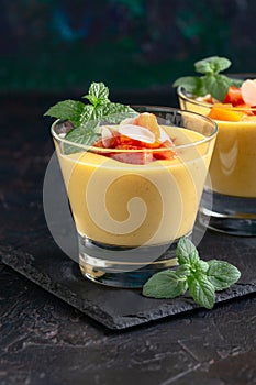 Creamy peach dessert with peach pieces and mint