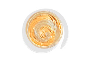 Creamy peanut butter in glass bowl isolated on white background, top view