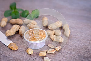 Creamy peanut butter with nut on wood table