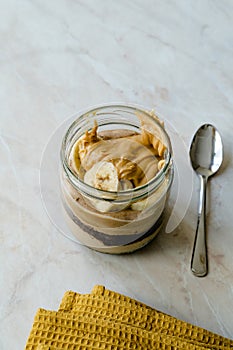 Creamy Peanut Butter Pie Dessert with Banana Slice and Chocolate Cake in Jar / Paleo Diet Cup