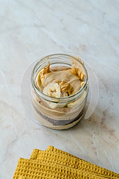 Creamy Peanut Butter Pie Dessert with Banana Slice and Chocolate Cake in Jar / Paleo Diet Cup