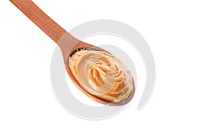 Creamy peanut butter in wooden spoon isolated on white background, closeup
