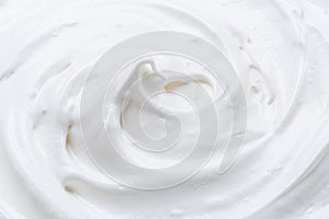 Creamy pic and waves in yoghurt or cream surface. Top view