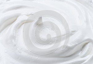 Creamy pic and waves in yoghurt or cream surface. Top view