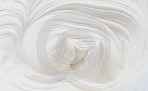 Creamy pics and swirls in yoghurt or cream surface. Top view