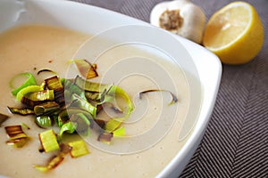 Creamy potato soup with fried leek detail