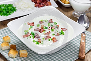 Creamy potato soup garnished with bacon