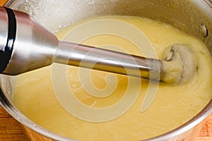 Creamy pureed celery soup recipe. Blended vegetables in a cooking pan close-up