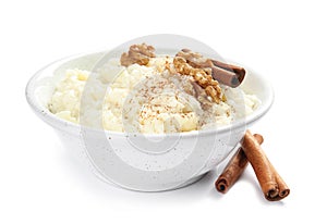 Creamy rice pudding with cinnamon and walnuts in bowl