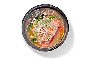 Creamy salmon miso soup with white miso paste, dried alaria, shiitake, rice noodles, chopped scallions and sesame