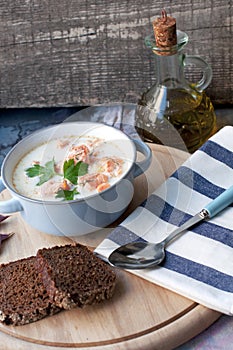 Creamy salmon soup Kalakeitto with spoon