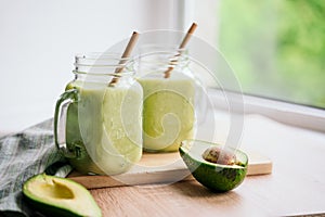 creamy smoothie from avocado and banana in glass cups