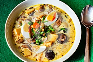 Creamy soup with boiled eggs, potato, carrot and different mushrooms