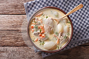 Creamy soup with chicken and vegetables close up. Horizontal top