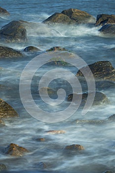 Creamy surf among rocks near shore, Hammonasset Beach, Madison,