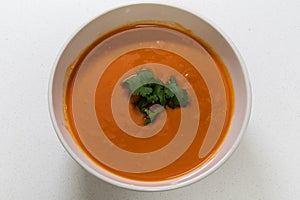 Creamy tomato soup with fresh coriander leaves