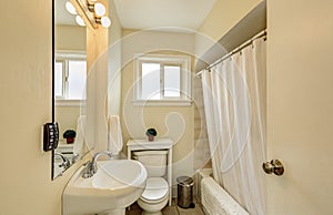 Creamy tones bathroom interior in old craftsman house