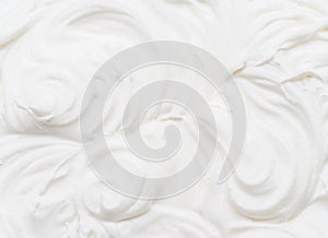 Creamy waves and swirls in yoghurt or cream surface. Top view