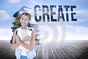 Create against stack of books against sky