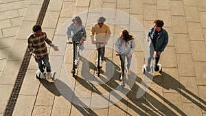 Create memories for your life. Joyful friends riding kick scooters and segways
