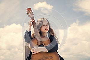 create new song. small guitar player on sky background. country music style. string musical instrument. play on acoustic