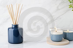 Create a serene atmosphere with navy blue reed diffuser and soft beige candles on marble