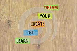 Create your dream symbol. Concept words Learn to create your dream on colored paper. Beautiful wooden table wooden background.