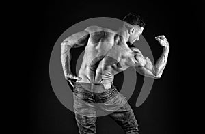 Create your power. Athletic trainer black background. Athletic man show biceps triceps. Sexy sportsman flex arm muscles