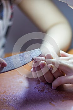 Creating artificial nails manicured female hand.