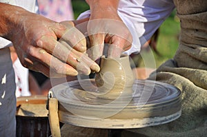 Creating ceramic cup by potter