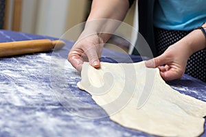 Creating homemade Phyllo or strudel dough on a home table cloth