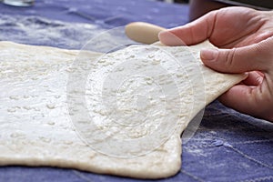 Creating homemade Phyllo or strudel dough on a home table cloth