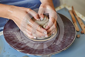 Creating jar or vase of clay. Woman hands, potter`s wheel photo
