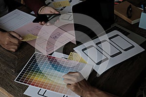 Until creating a mobile application, a developer compares color and interface wireframes