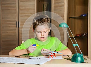 Creating the model plane. Happy boy making aircraft model. Hobby concept.