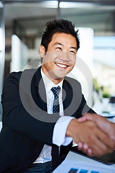 Creating partnerships. corporate businesspeople shaking hands in the workplace.
