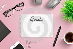 Creating plan of business goals concept on pink work desk