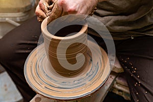 Creating a pot of clay close-up. Hands making products from clay. Potter at work