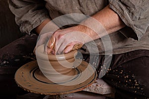 Creating a pot of clay close-up. Hands making products from clay. Potter at work